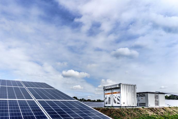 white and black solar panels under white clouds and blue sky during daytime